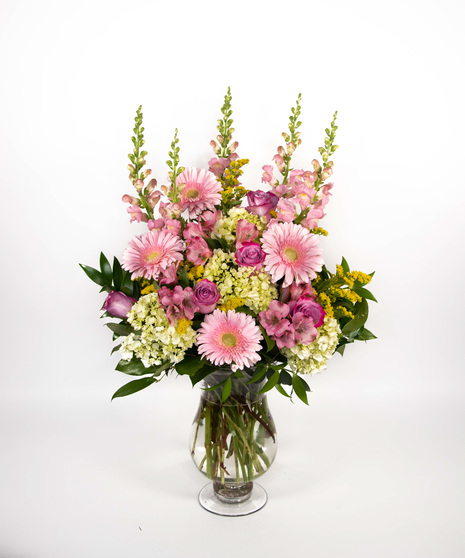 pink and butter-yellow arrangement in tall presentation style